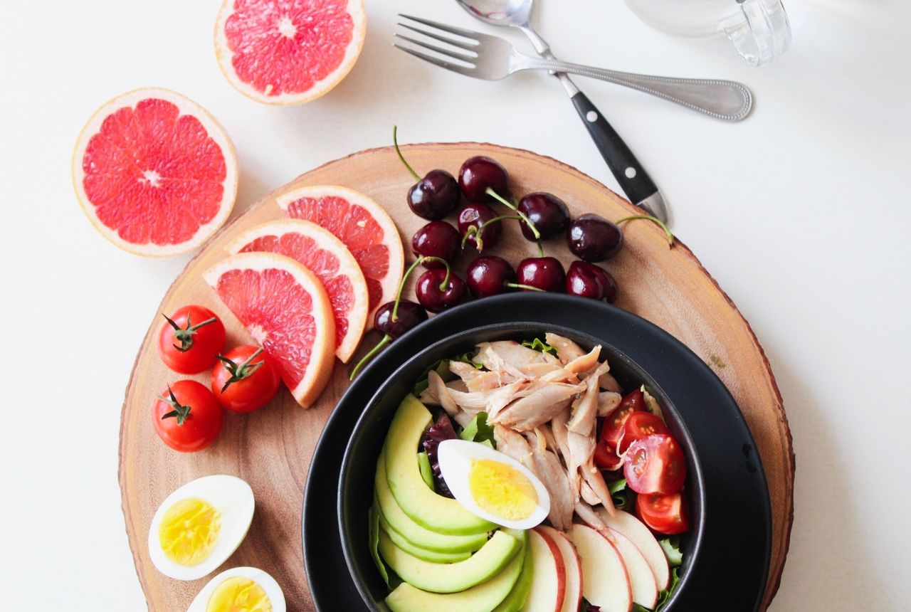 A vibrant high-protein meal of salmon, eggs, and fresh vegetables